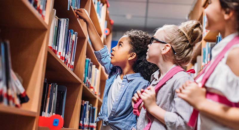School Girls Looking For Books